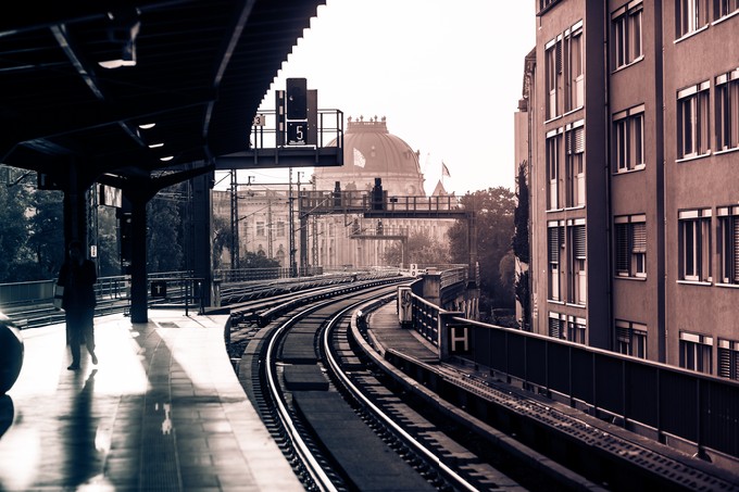 Vintage train station with railway lines in Berlin. Retro filtered. Monochrome cream tone. Black and white photography
