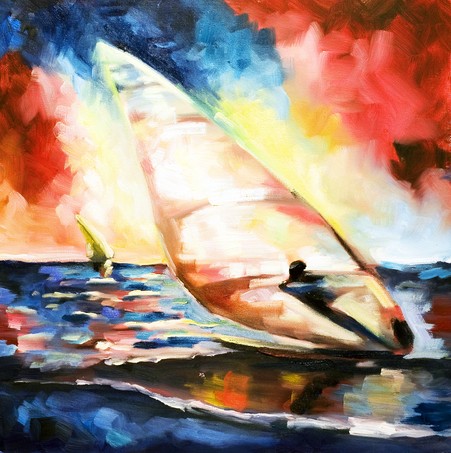 Windsurfer on waves against the sunset and multi-colored sky